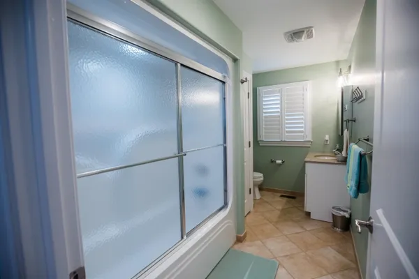 a bathroom with a glass shower door