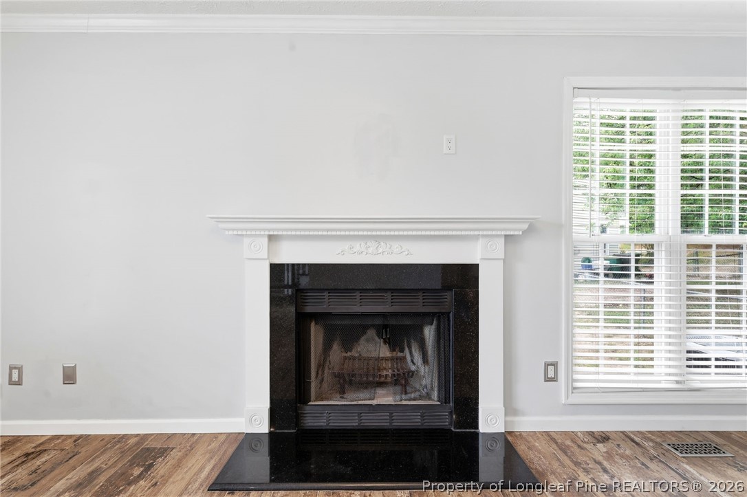 5113 Archer Road Hope Mills, NC 28348 - Photo 10 of 41 a living room with a fireplace and a window
