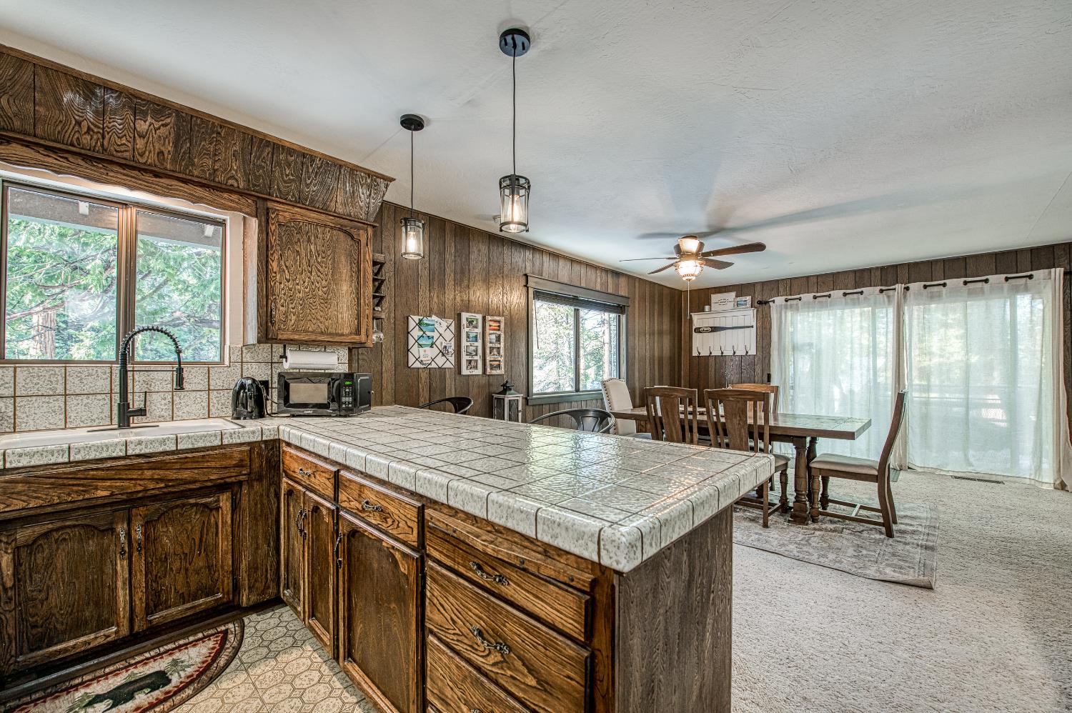 42488 Rock Ledge Road Shaver Lake, CA 93664 - Photo 16 of 37 a open kitchen with a sink a stove and chairs