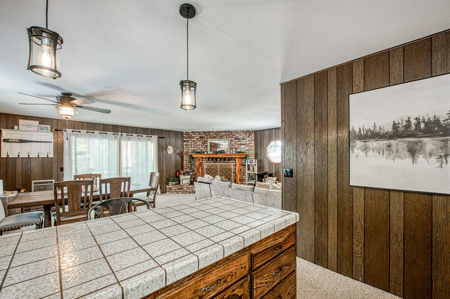 42488 Rock Ledge Road Shaver Lake, CA 93664 - Photo 18 of 37 a dining hall with stainless steel appliances kitchen island granite countertop a table chairs in it and a large window