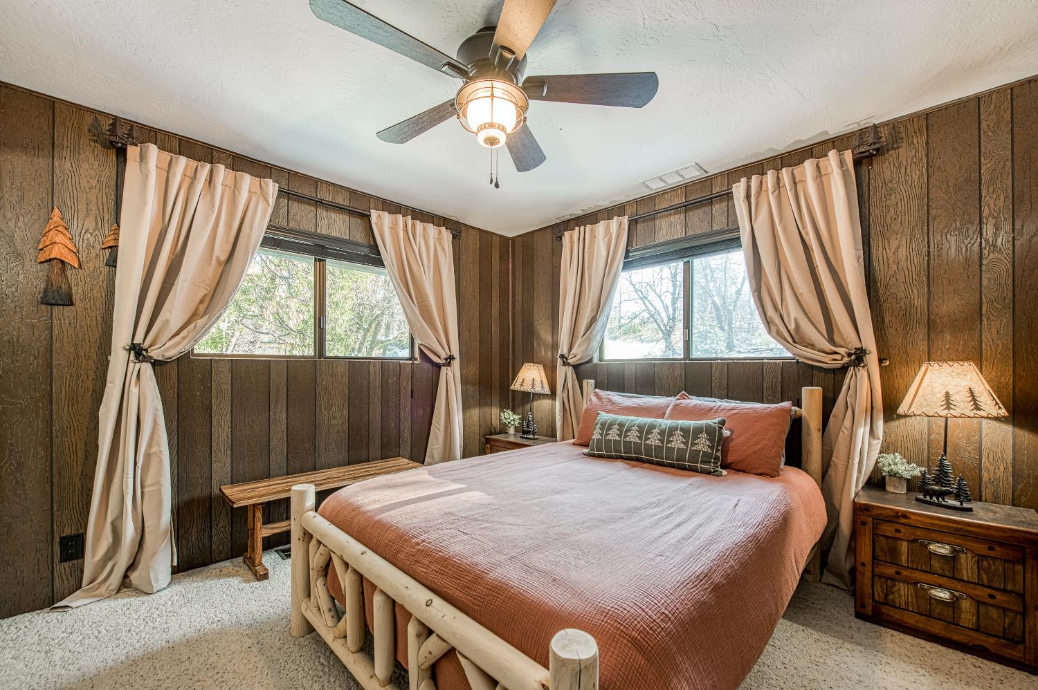 42488 Rock Ledge Road Shaver Lake, CA 93664 - Photo 19 of 37 a bedroom with a large bed and a chandelier