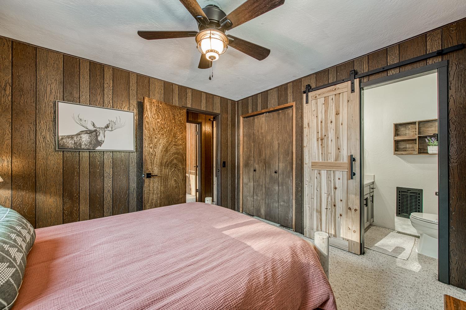 42488 Rock Ledge Road Shaver Lake, CA 93664 - Photo 20 of 37 a bedroom with a bed and a chandelier