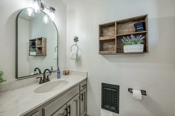 a bathroom with a sink and a mirror