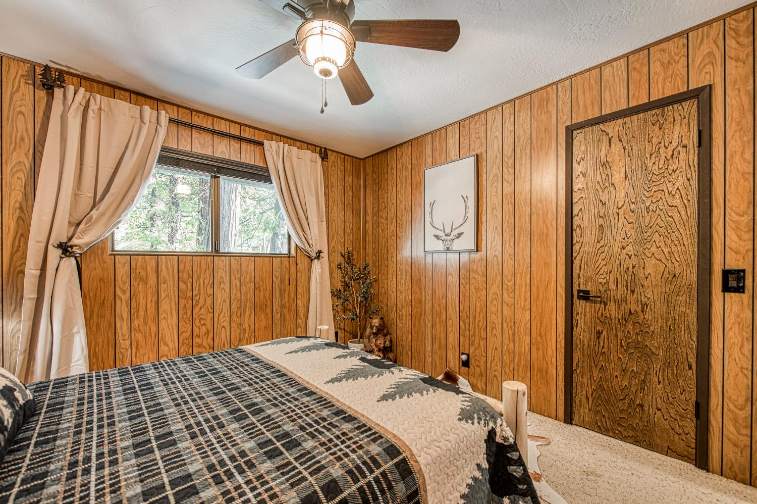 42488 Rock Ledge Road Shaver Lake, CA 93664 - Photo 23 of 37 a bedroom with a bed and a window