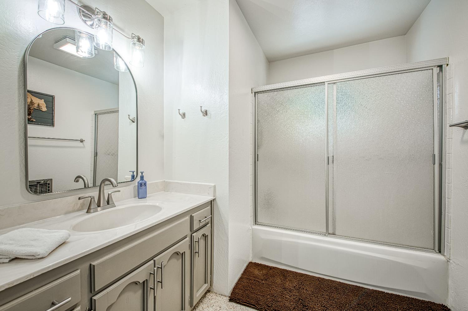 42488 Rock Ledge Road Shaver Lake, CA 93664 - Photo 24 of 37 a bathroom with a sink and a mirror