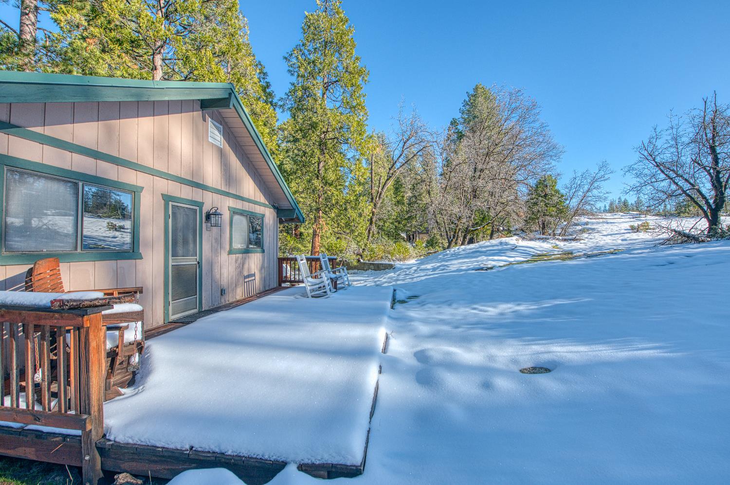 42488 Rock Ledge Road Shaver Lake, CA 93664 - Photo 4 of 37 a backyard of a house with table and chairs