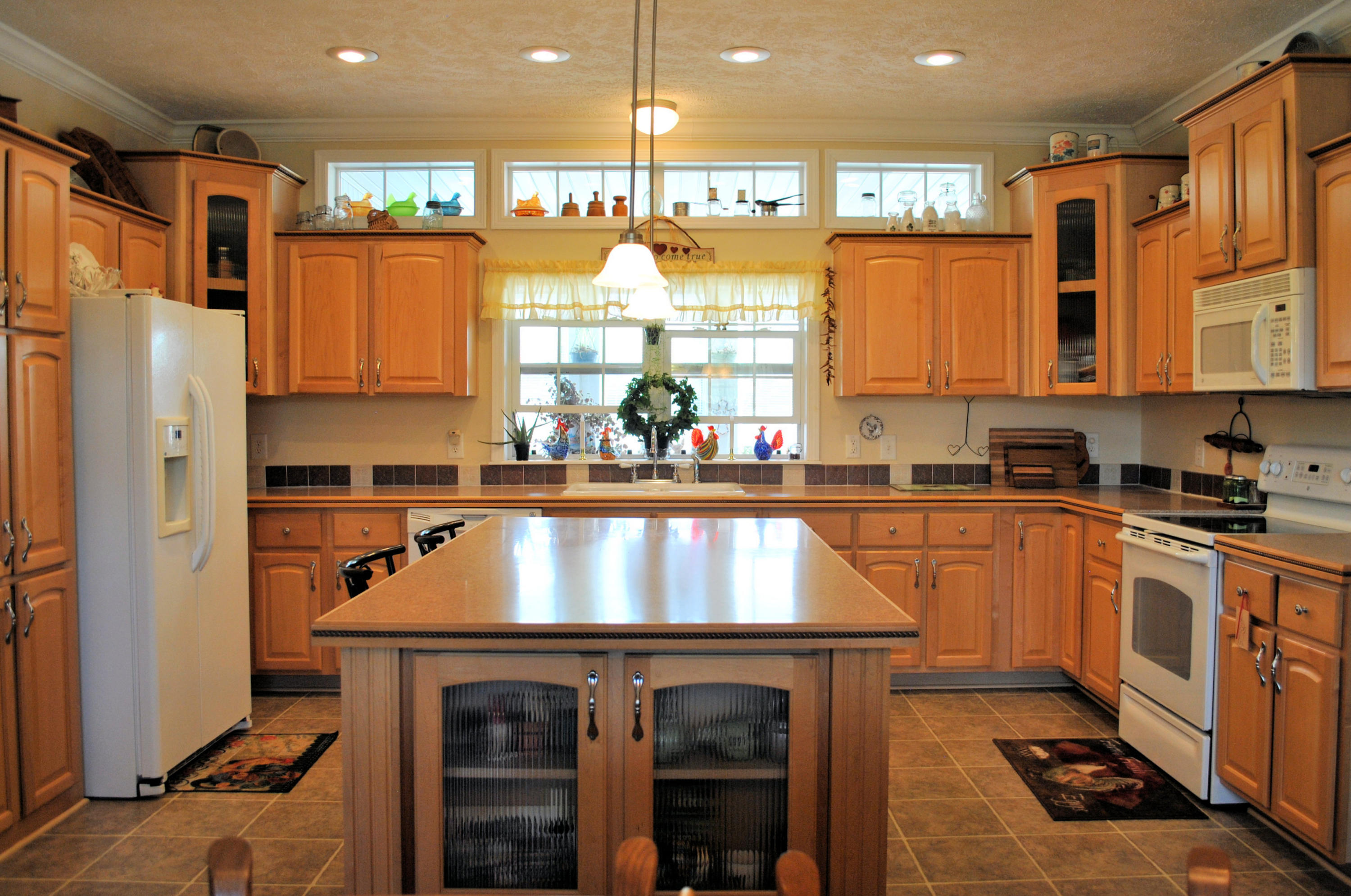 785 Union Valley Road Riner, VA 24149 - Photo 28 of 86 a kitchen with kitchen island granite countertop a refrigerator a sink and a stove