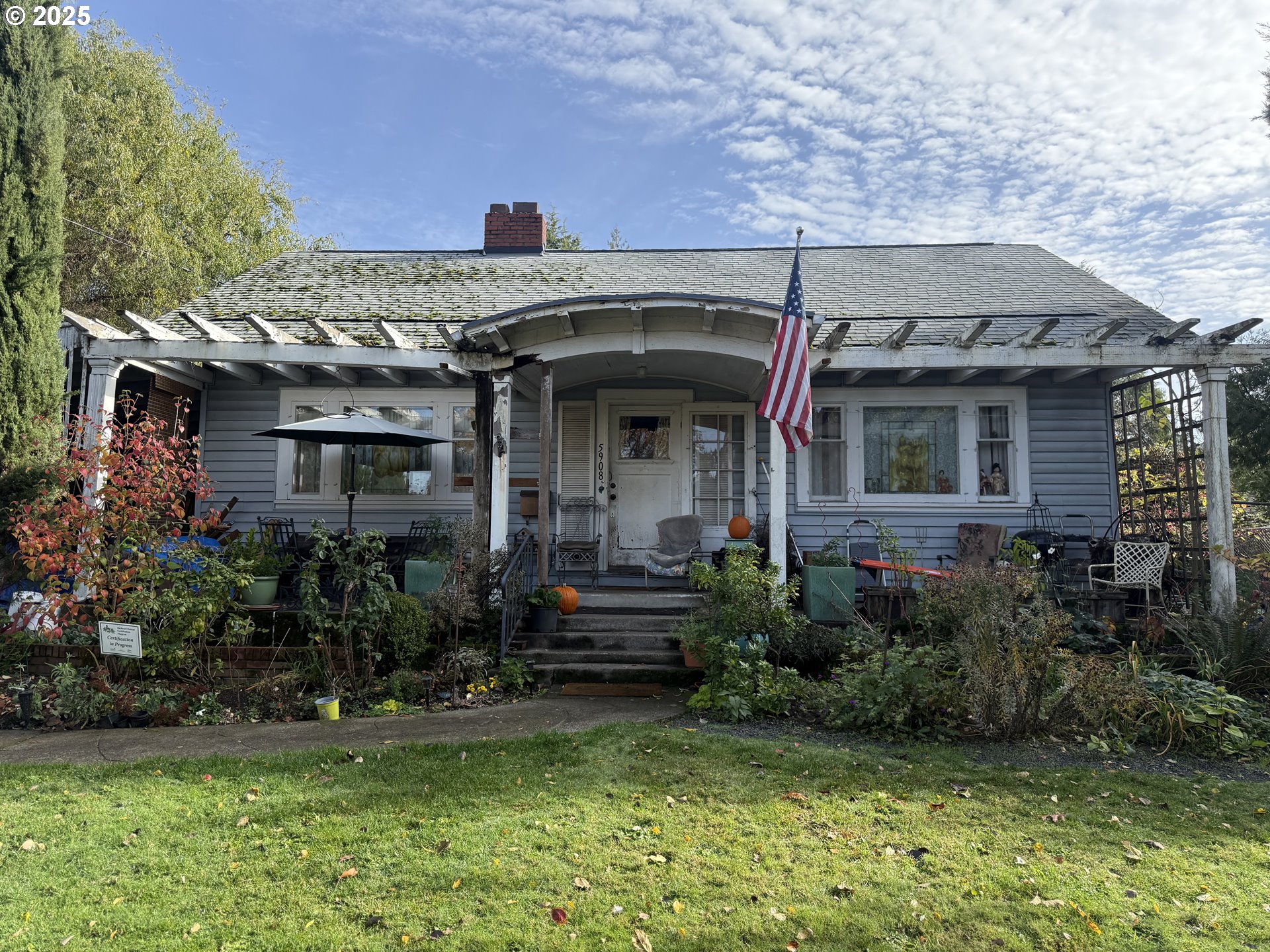 a view of a house with brick walls and a yard