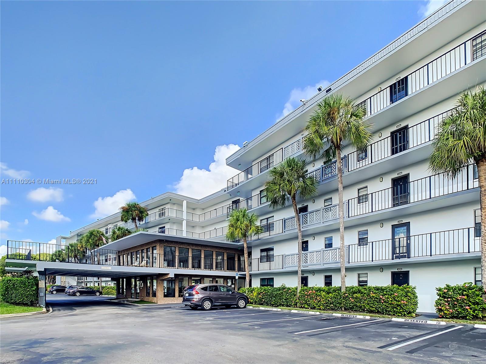9235 Southwest 8th Street, Unit 401 Boca Raton, FL 33428 - Photo 2 of 40 a view of a building with a garden