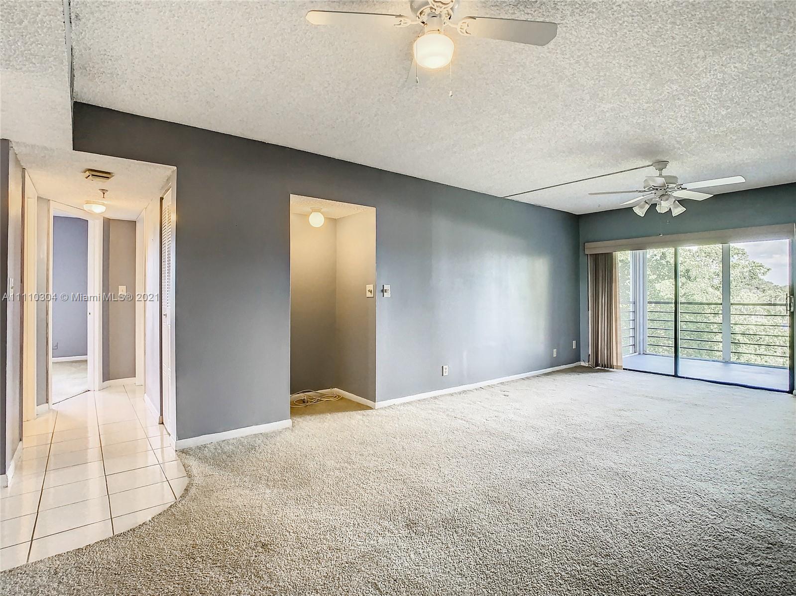 9235 Southwest 8th Street, Unit 401 Boca Raton, FL 33428 - Photo 12 of 40 a view of an empty room with a window