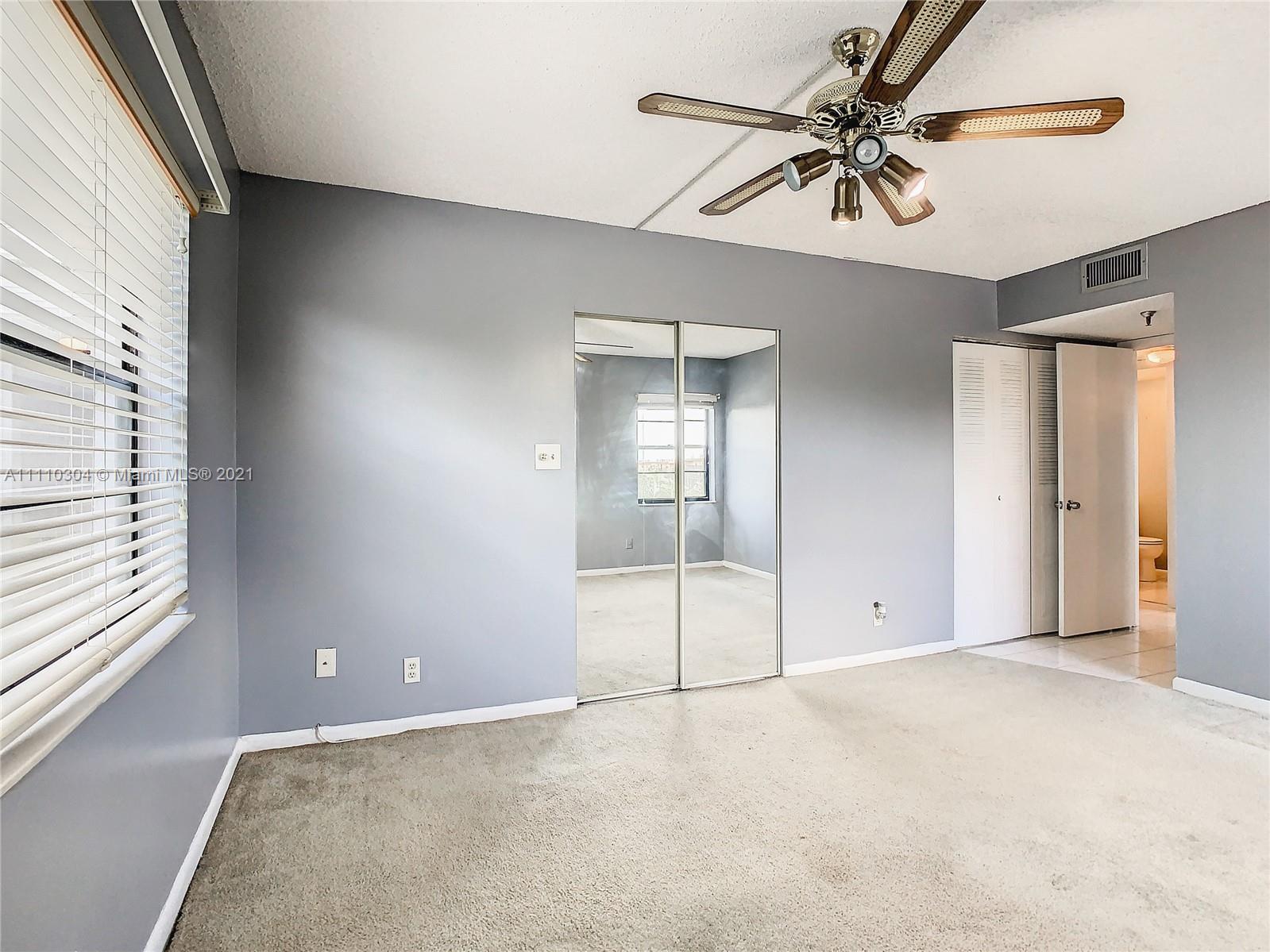 9235 Southwest 8th Street, Unit 401 Boca Raton, FL 33428 - Photo 25 of 40 a view of an empty room with a window