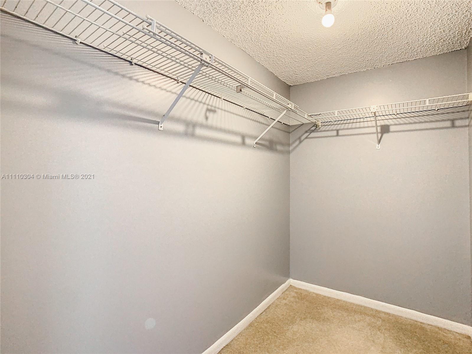 9235 Southwest 8th Street, Unit 401 Boca Raton, FL 33428 - Photo 27 of 40 a view of a room with racks on the wall