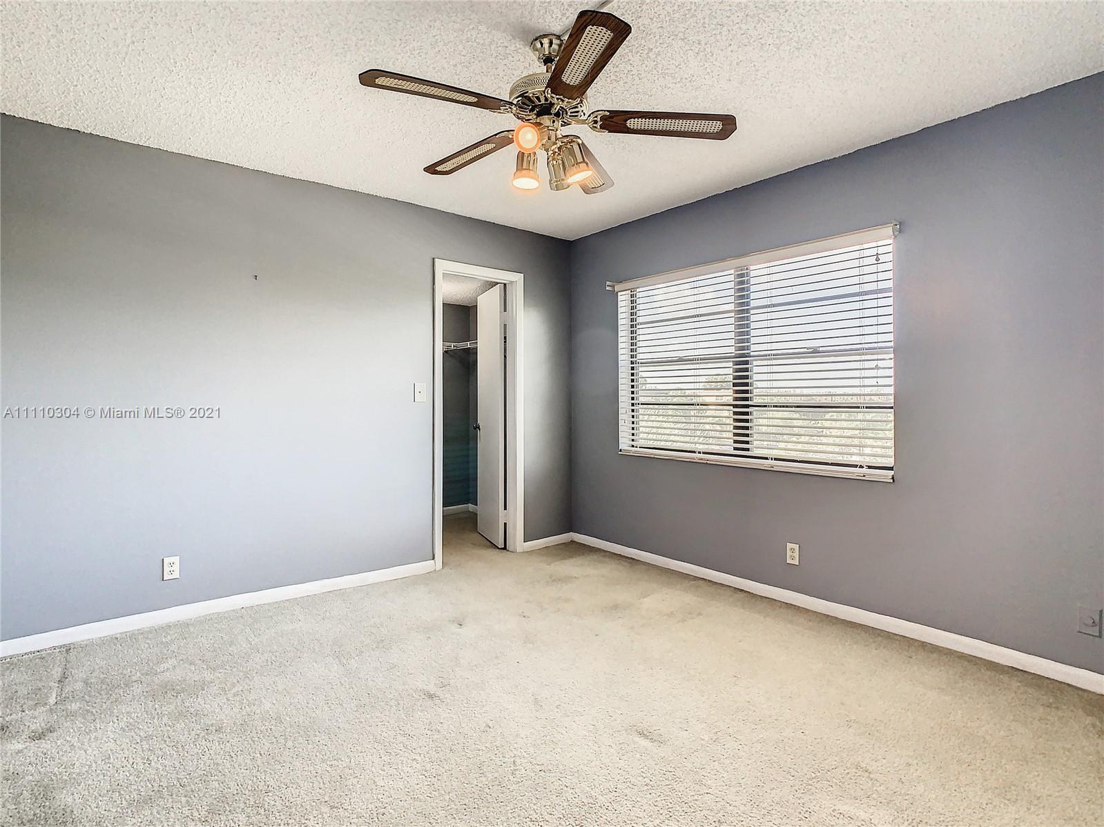 9235 Southwest 8th Street, Unit 401 Boca Raton, FL 33428 - Photo 31 of 40 a view of a livingroom with a ceiling fan and window