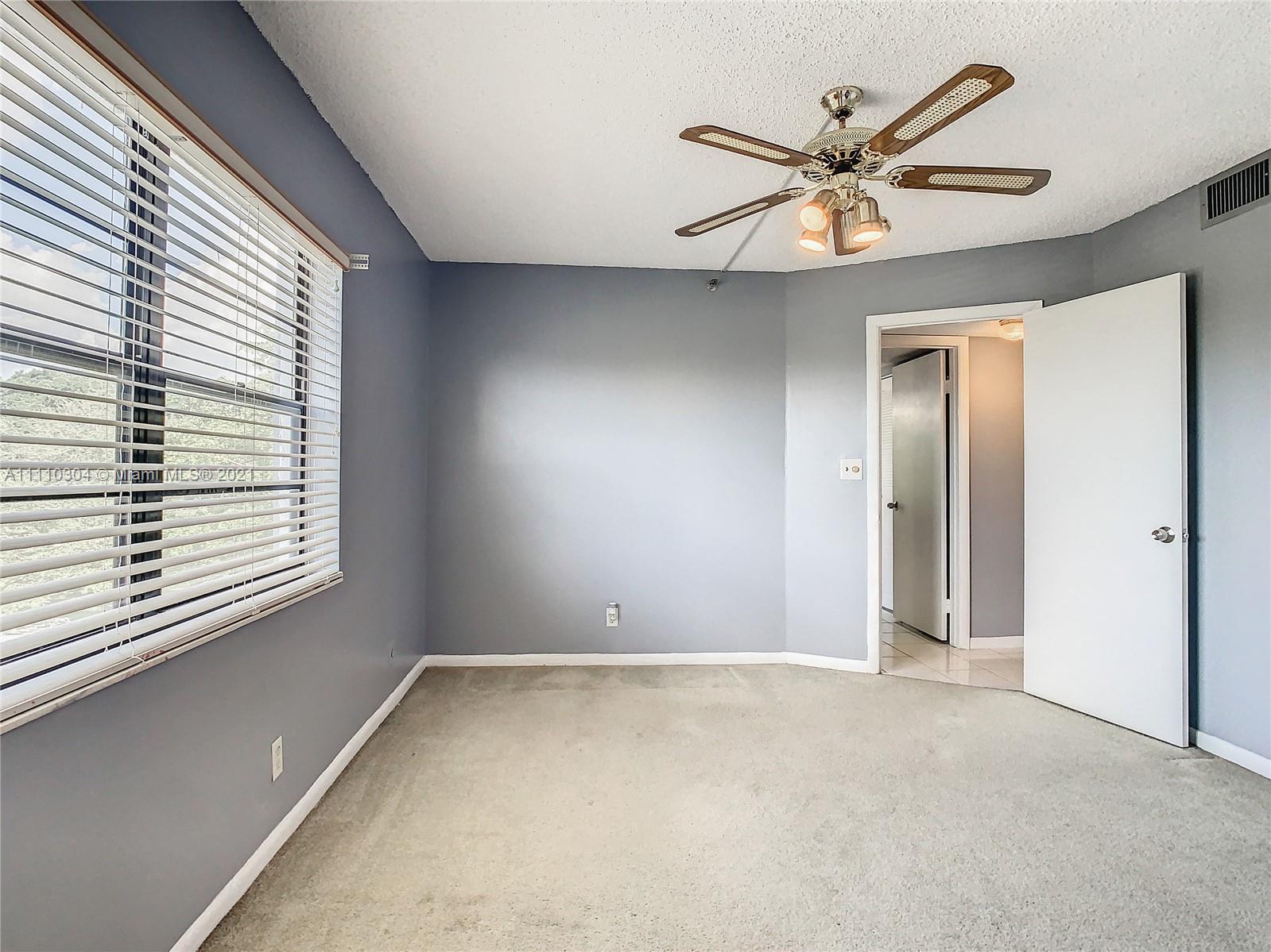 9235 Southwest 8th Street, Unit 401 Boca Raton, FL 33428 - Photo 32 of 40 a view of an empty room with a window