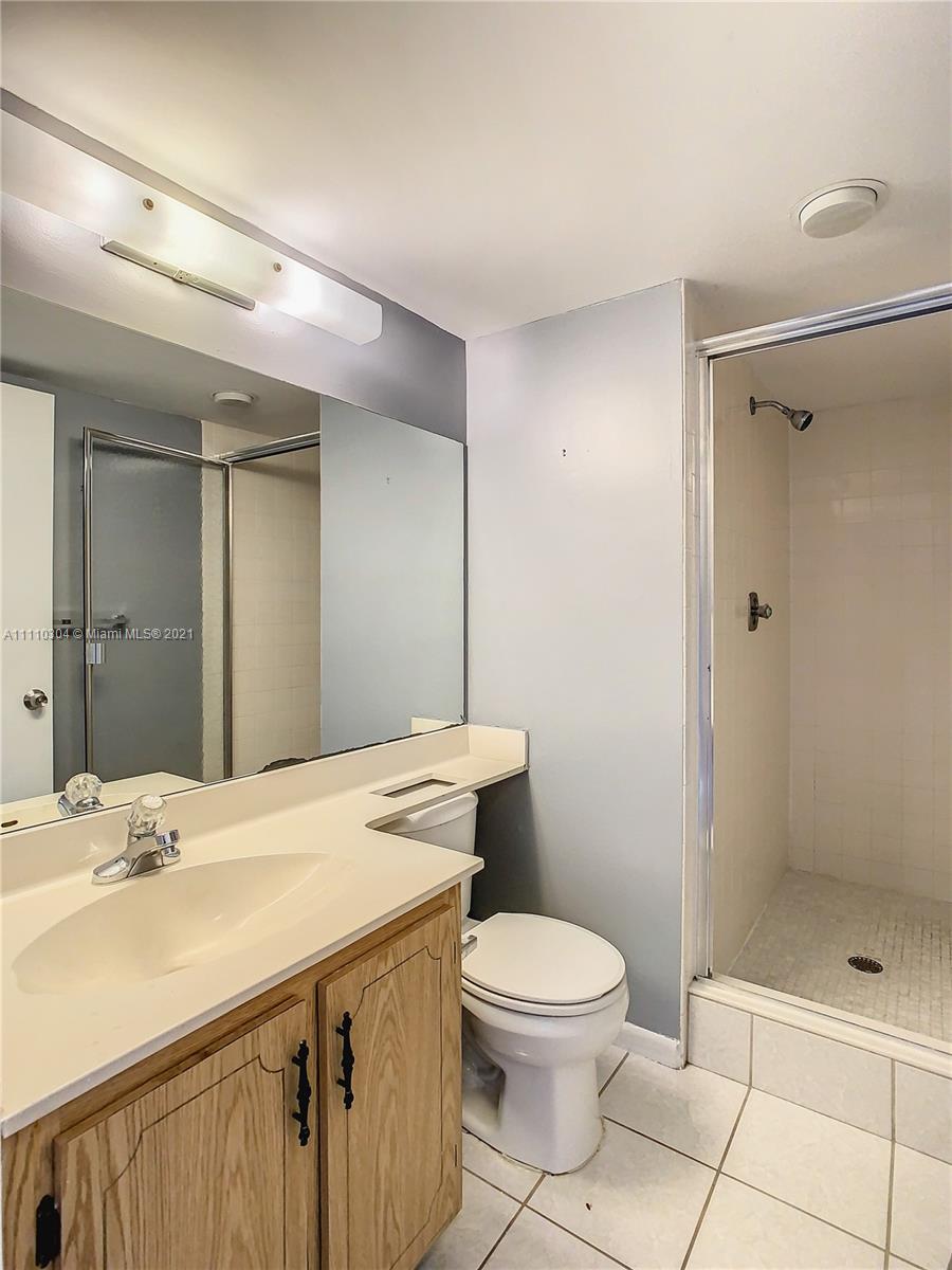 9235 Southwest 8th Street, Unit 401 Boca Raton, FL 33428 - Photo 33 of 40 a bathroom with a sink a toilet and shower