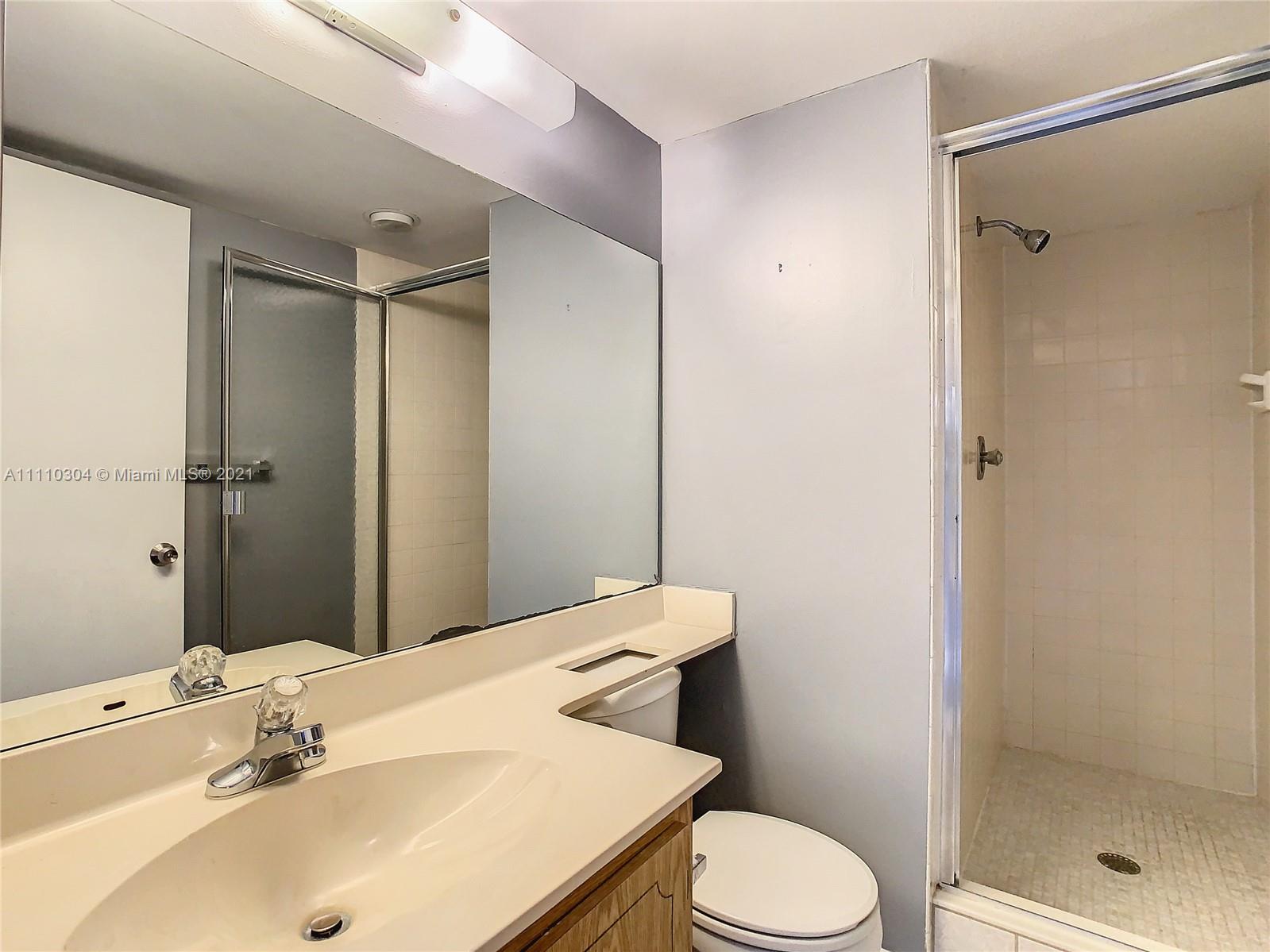9235 Southwest 8th Street, Unit 401 Boca Raton, FL 33428 - Photo 34 of 40 a bathroom with a sink toilet and shower