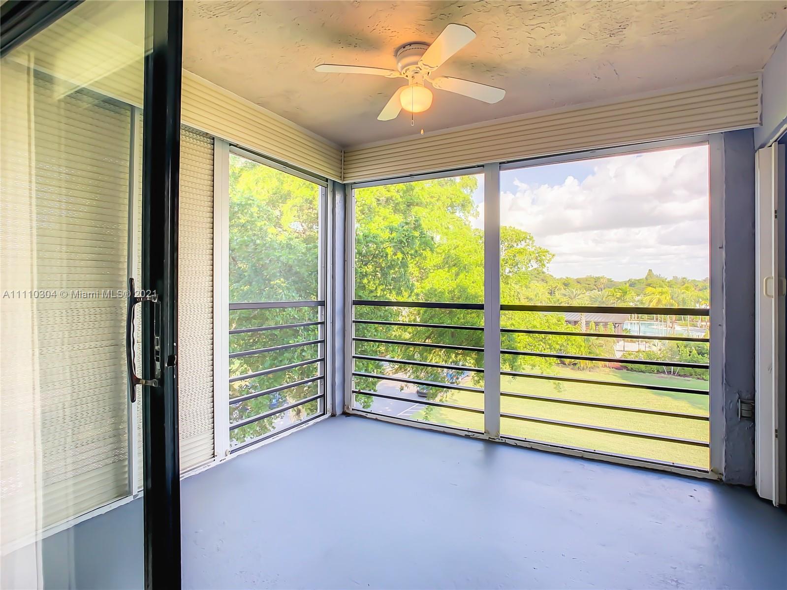 9235 Southwest 8th Street, Unit 401 Boca Raton, FL 33428 - Photo 35 of 40 a view of room with window and a ceiling fan