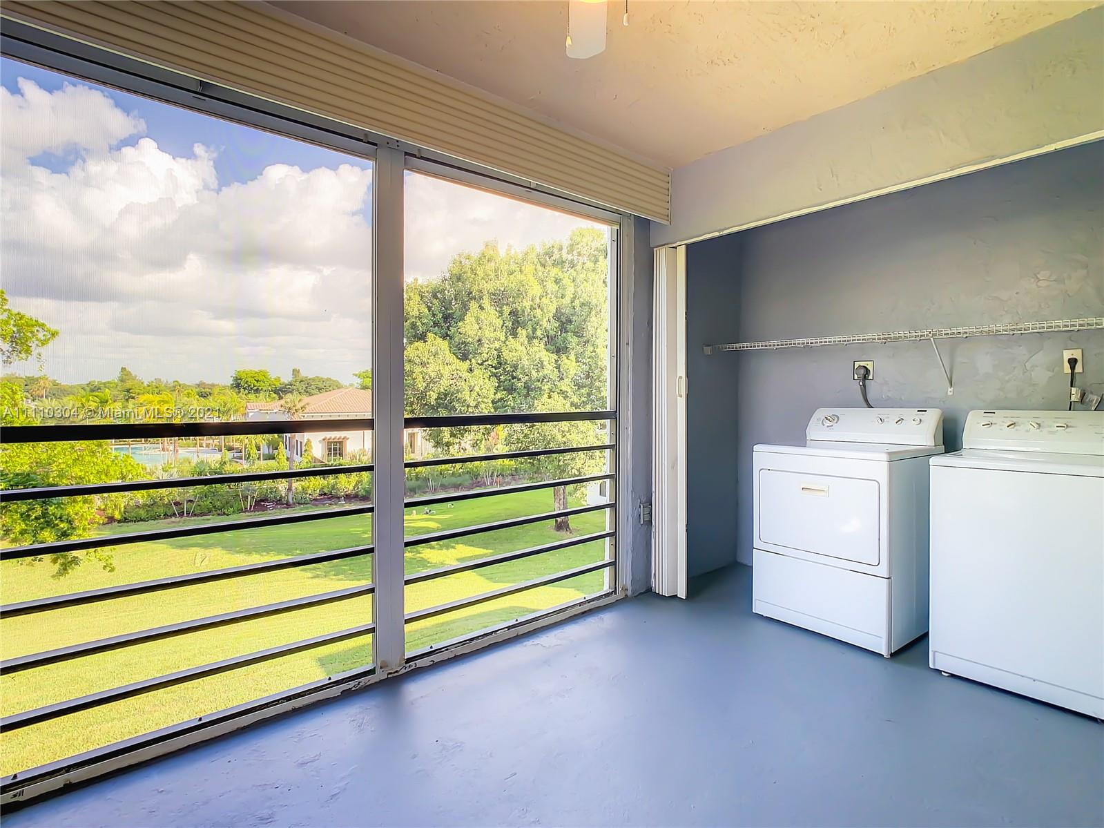9235 Southwest 8th Street, Unit 401 Boca Raton, FL 33428 - Photo 36 of 40 a utility room with dryer and washer