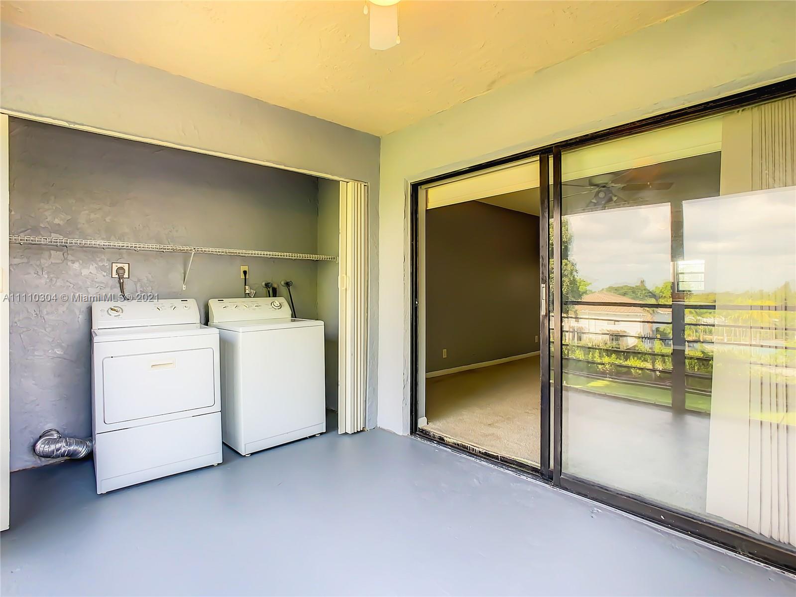 9235 Southwest 8th Street, Unit 401 Boca Raton, FL 33428 - Photo 37 of 40 a utility room with dryer and washer
