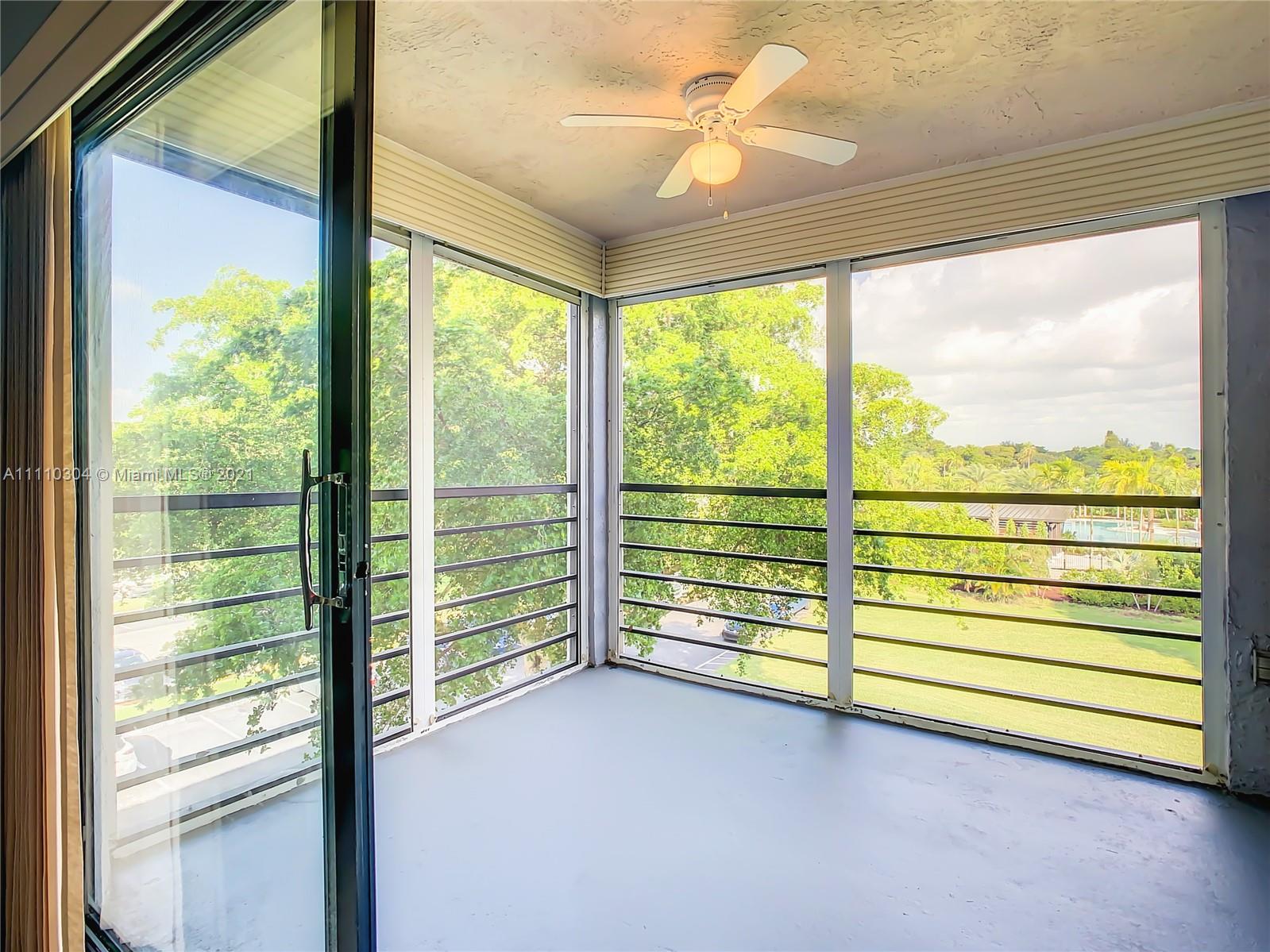 9235 Southwest 8th Street, Unit 401 Boca Raton, FL 33428 - Photo 38 of 40 a view of a room with air conditioner and a floor to ceiling window