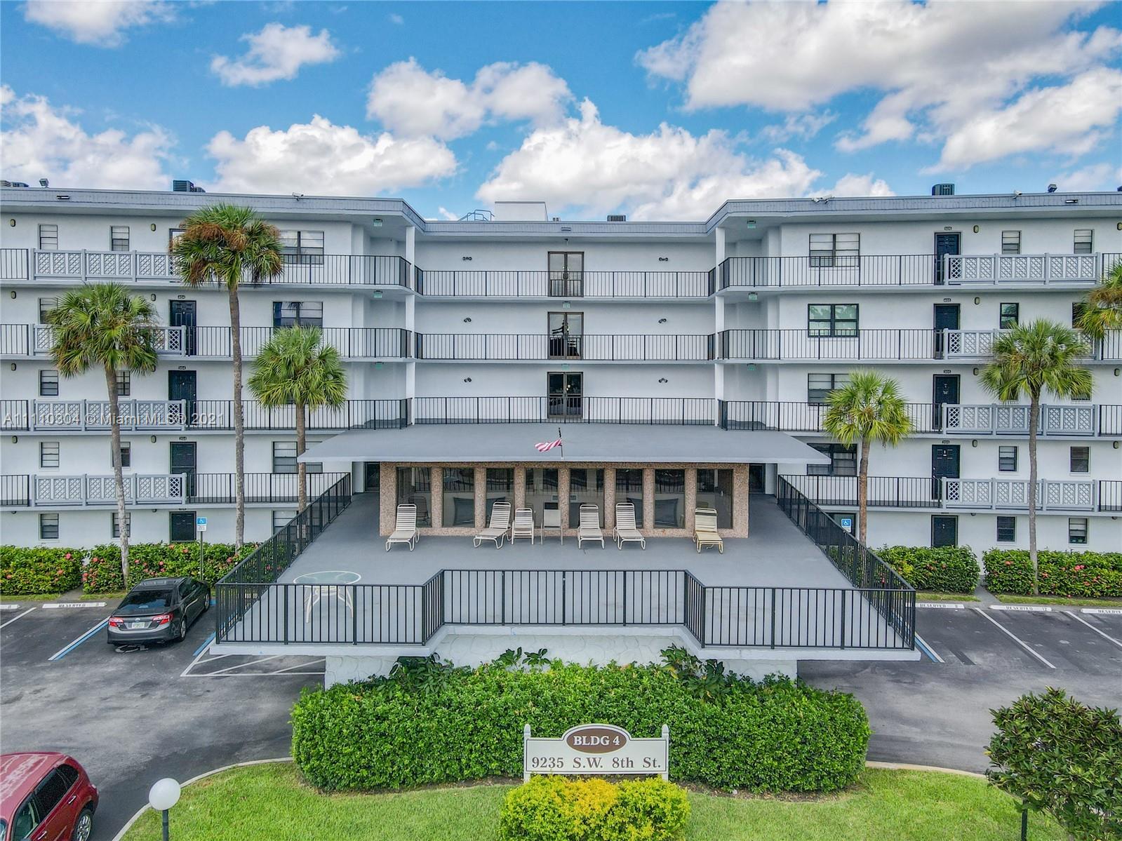 9235 Southwest 8th Street, Unit 401 Boca Raton, FL 33428 - Photo 5 of 40 a view of a buildings in front of a big yard
