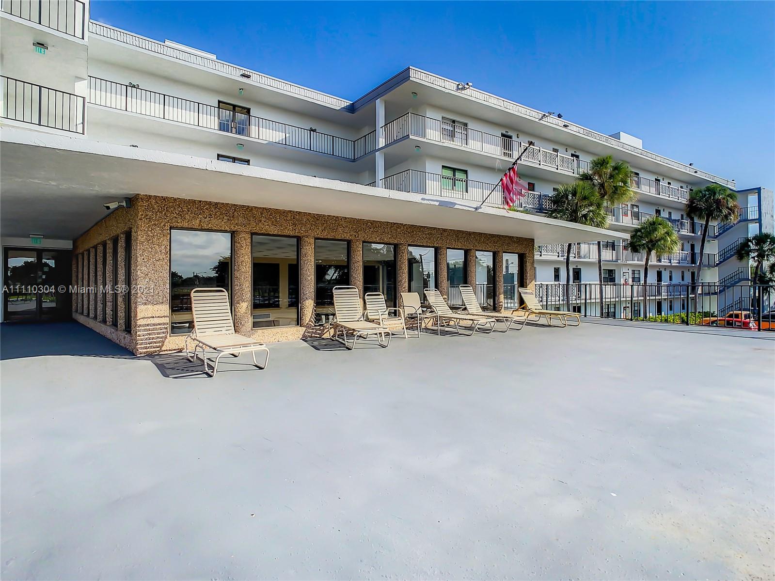 9235 Southwest 8th Street, Unit 401 Boca Raton, FL 33428 - Photo 7 of 40 a view of a building with sitting area