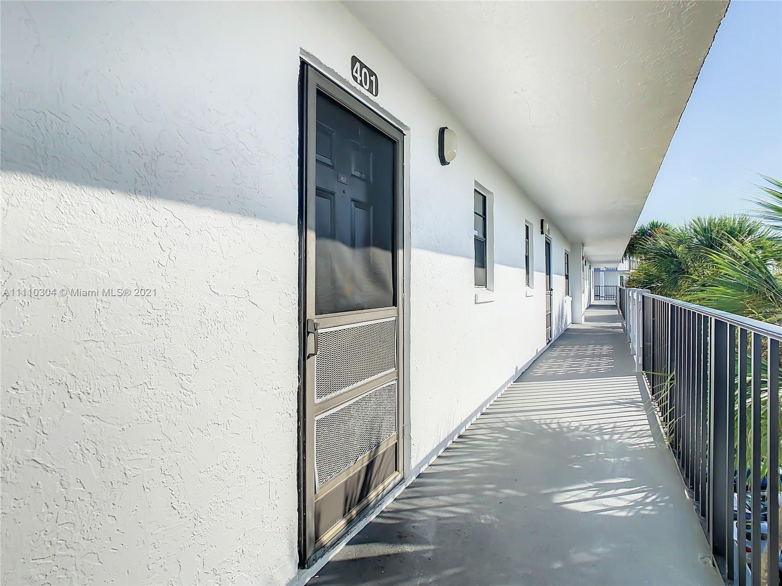 9235 Southwest 8th Street, Unit 401 Boca Raton, FL 33428 - Photo 8 of 40 a view of a hallway with wooden walls and stairs