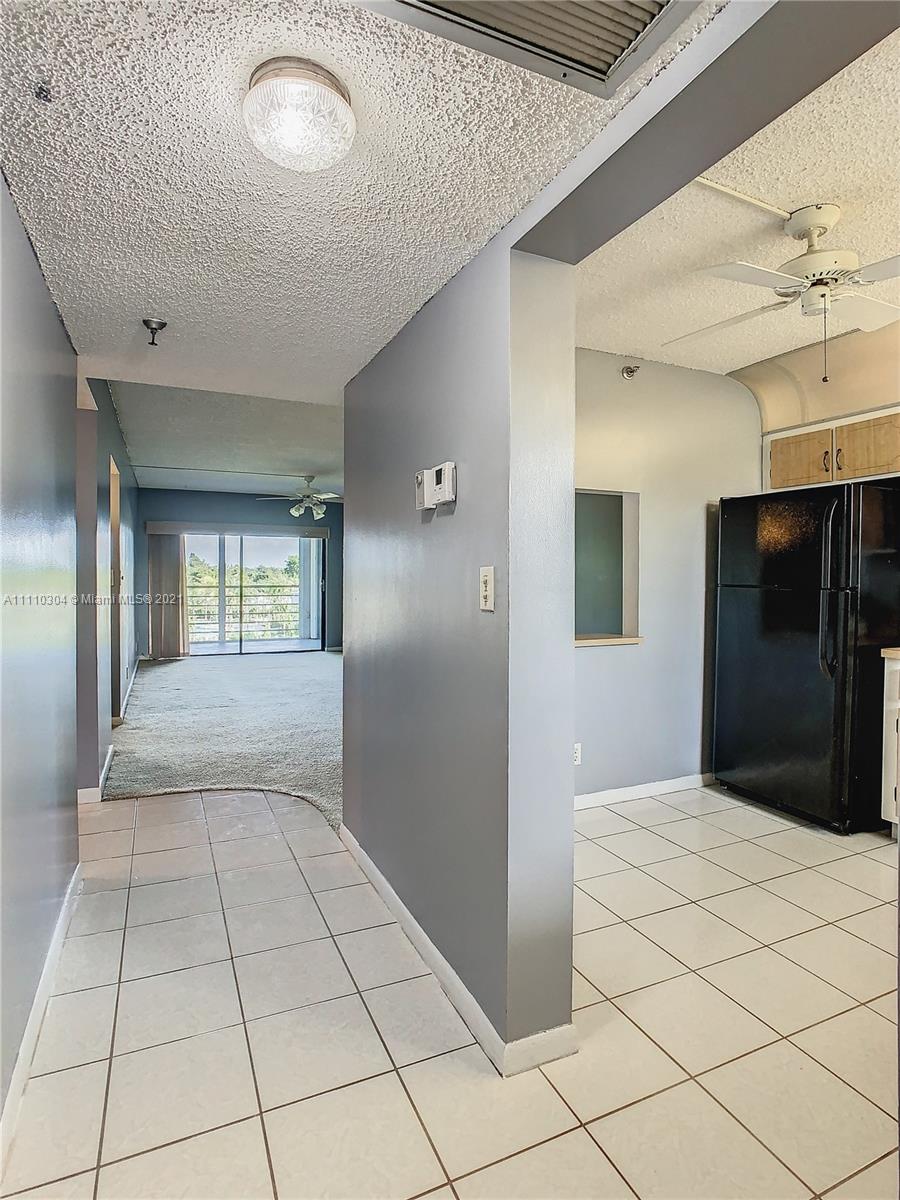 9235 Southwest 8th Street, Unit 401 Boca Raton, FL 33428 - Photo 10 of 40 a view of hallway with a large window