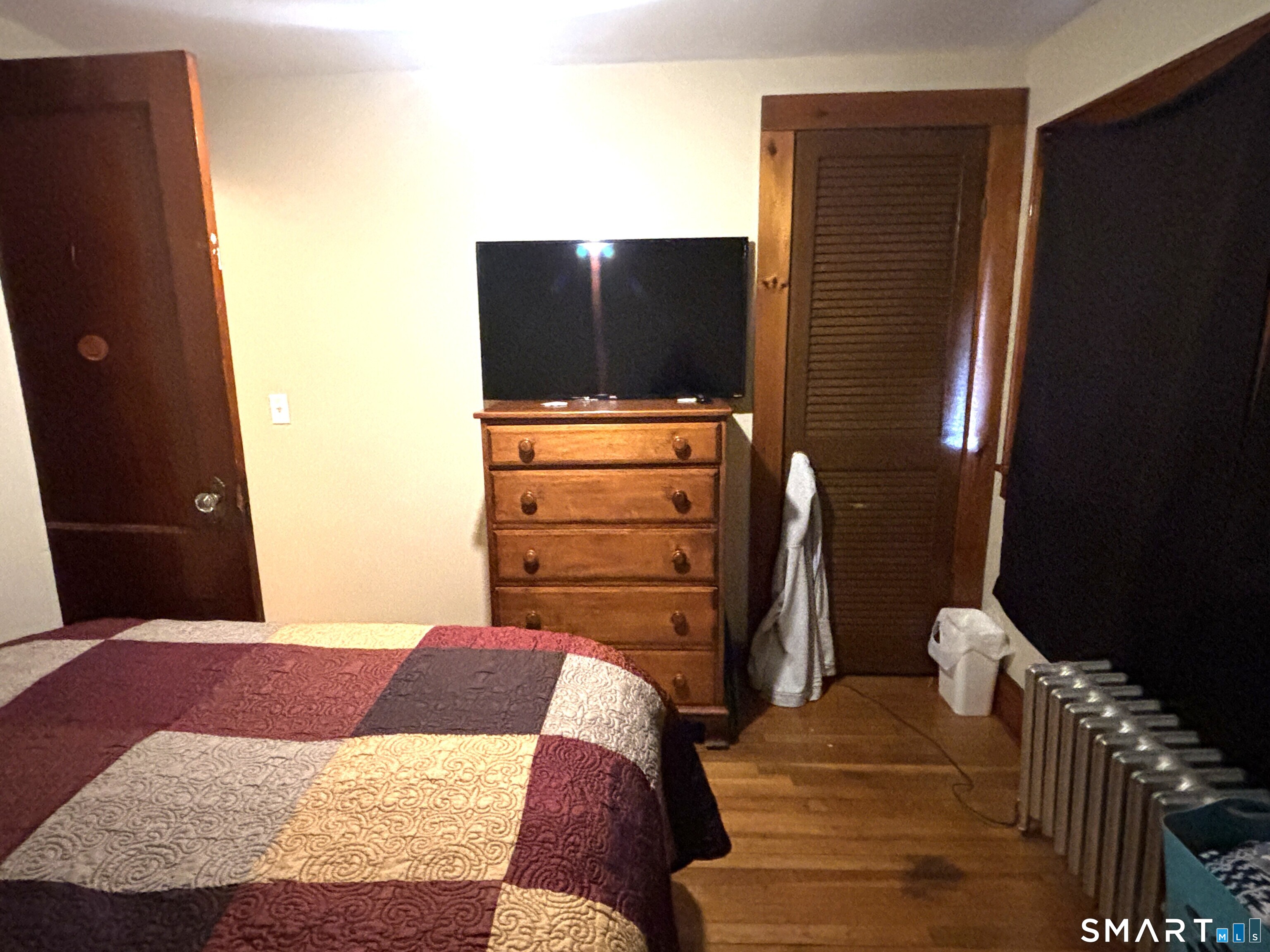 147 Halls Hill Road Colchester, CT 06415 - Photo 22 of 40 a bedroom with a bed and mirror