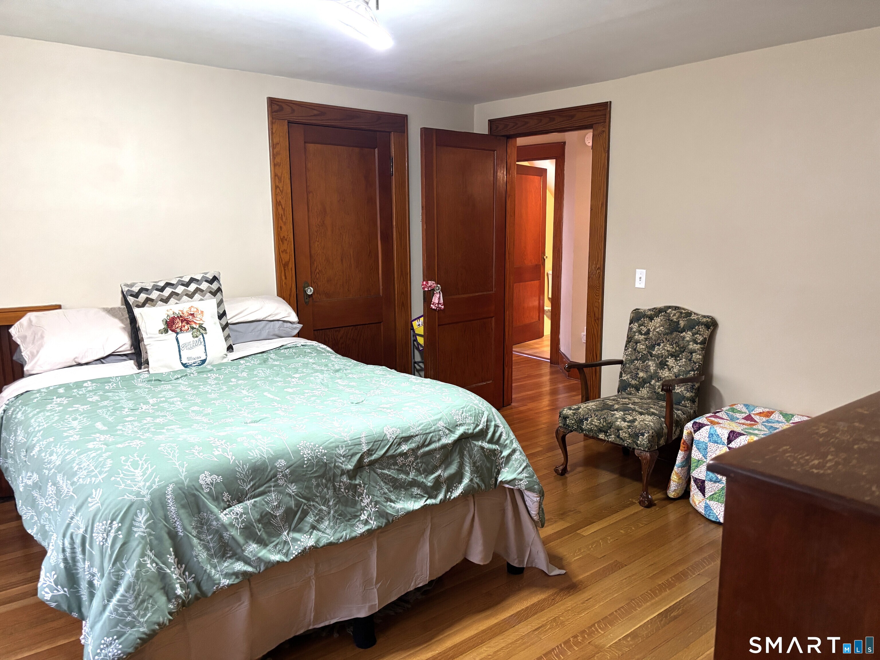 147 Halls Hill Road Colchester, CT 06415 - Photo 37 of 40 a bedroom with a bed and wooden floor