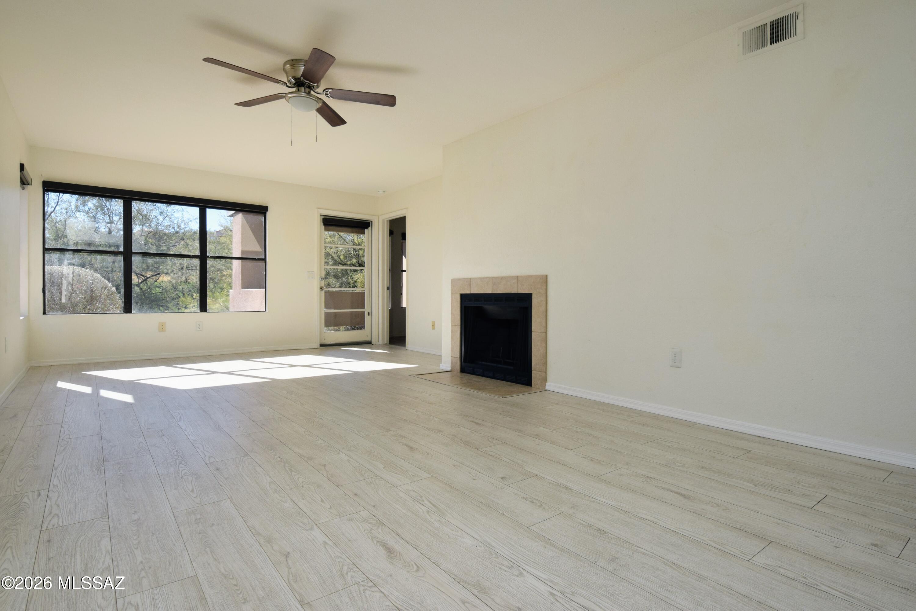 5855 North Kolb Road, Unit 11106 Tucson, AZ 85750 - Photo 1 of 36 an empty room with windows and fireplace