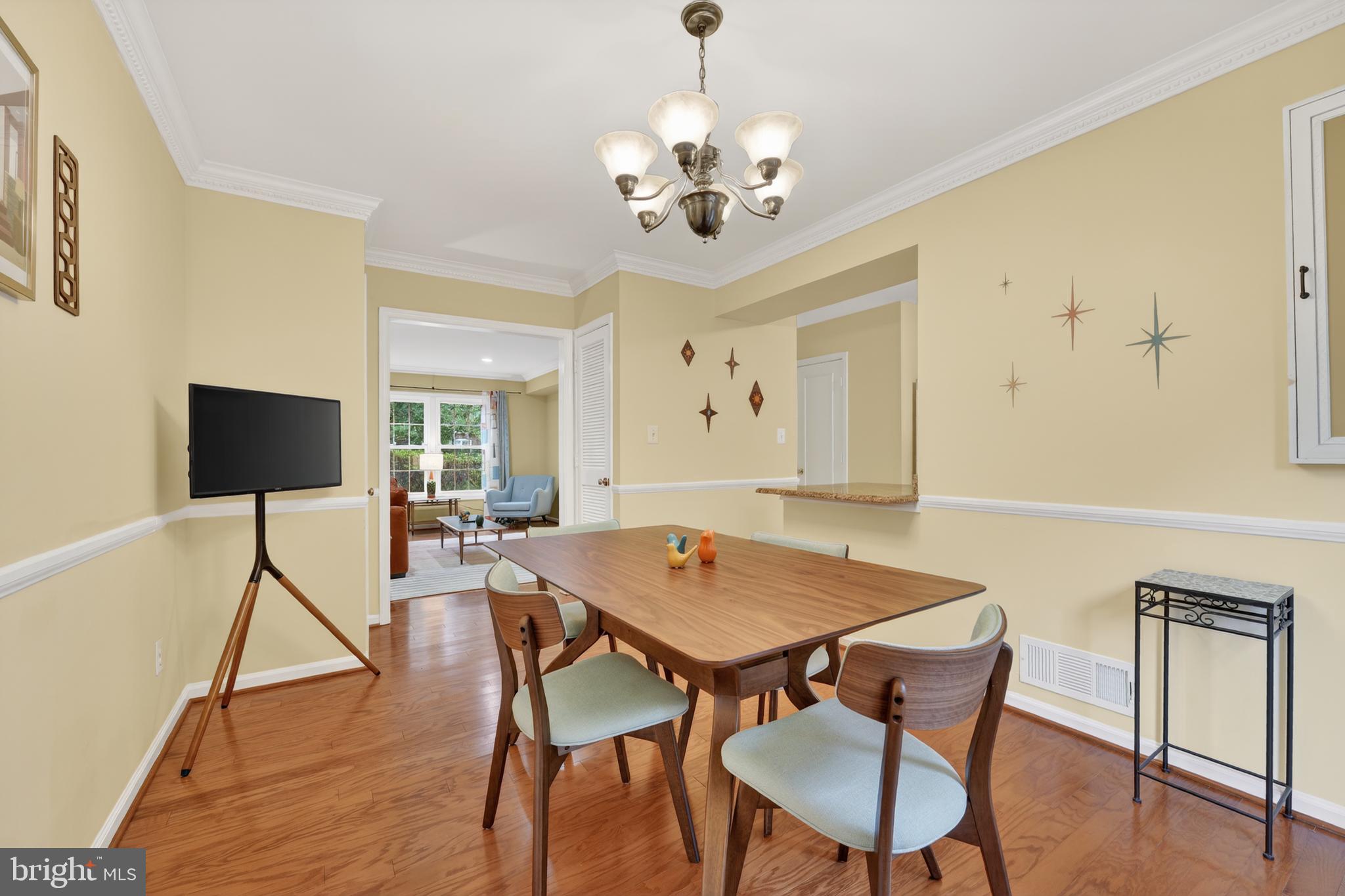 8139 Carrleigh Parkway Springfield, VA 22152 - Photo 4 of 27 a view of a dining room with furniture and wooden floor