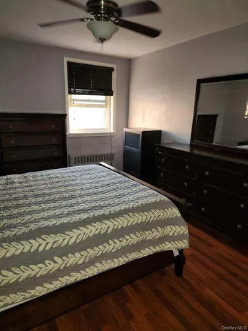 a bedroom with a bed and a flat tv screen