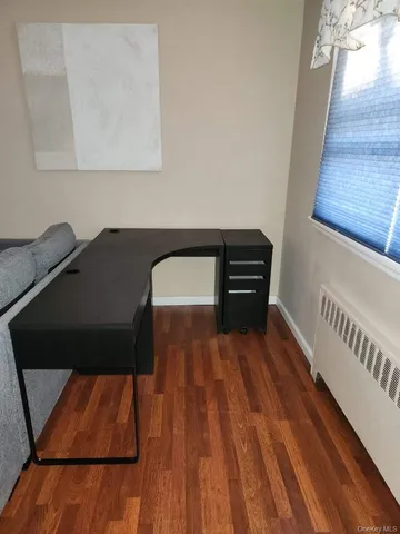 a view of workspace with wooden floor