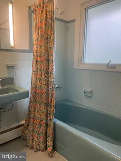a bathroom with a bathtub and shower