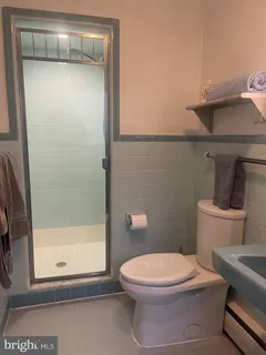 a white toilet sitting next to a bathroom sink