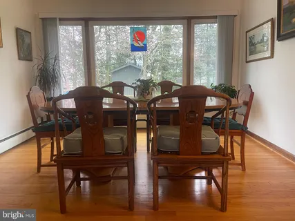 a view of a dining room with furniture window and wooden floor