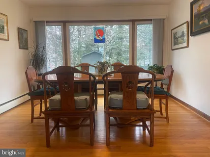 a view of a dining room with furniture window and wooden floor