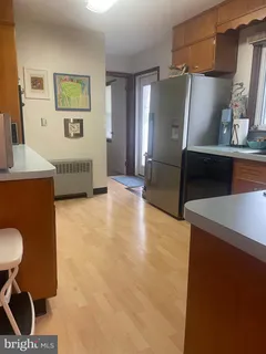 a view of kitchen with furniture and a refrigerator