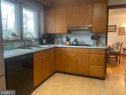 a kitchen with stainless steel appliances granite countertop a sink a stove and cabinets