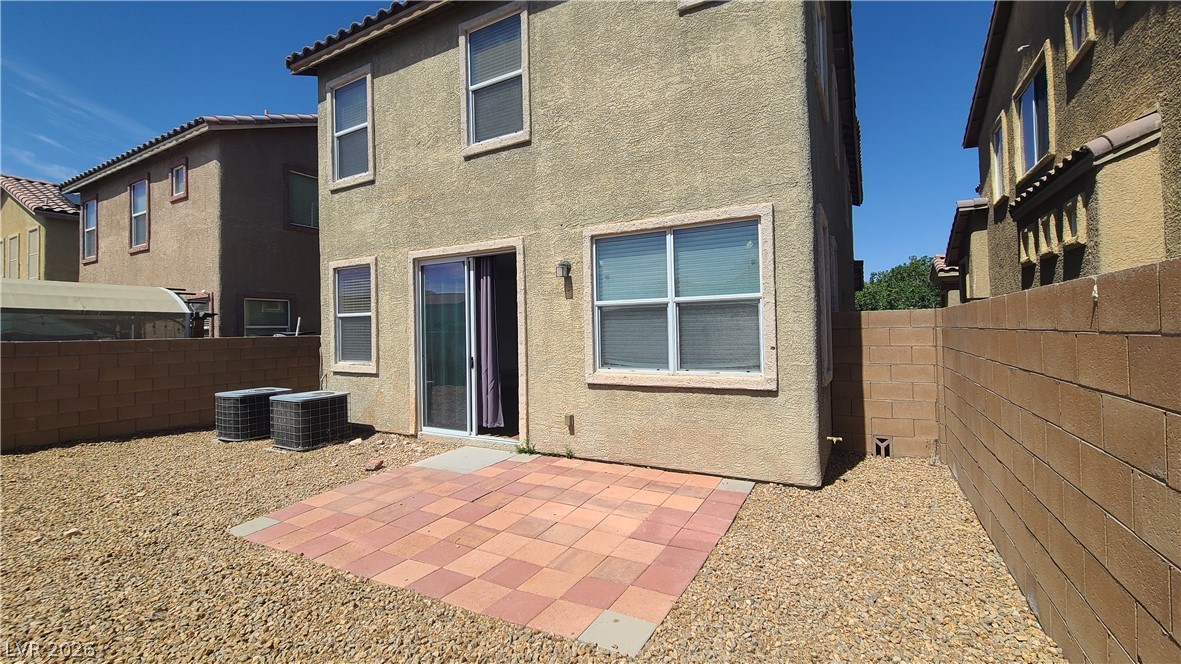 8944 Rutherford Grove Street Las Vegas, NV 89148 - Photo 32 of 35 A spacious backyard awaits, featuring a durable block wall fence and a charming patio for outdoor enjoyment.