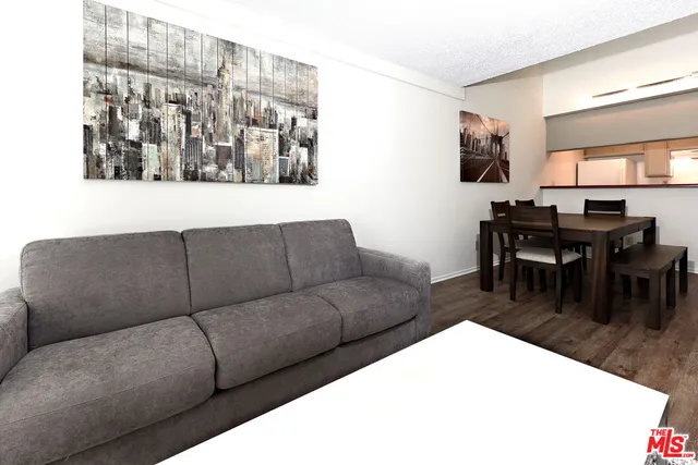 a living room with furniture and kitchen view