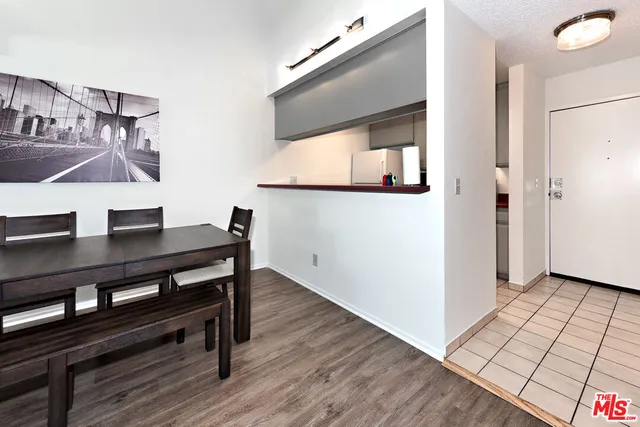a view of a workspace with furniture and wooden floor