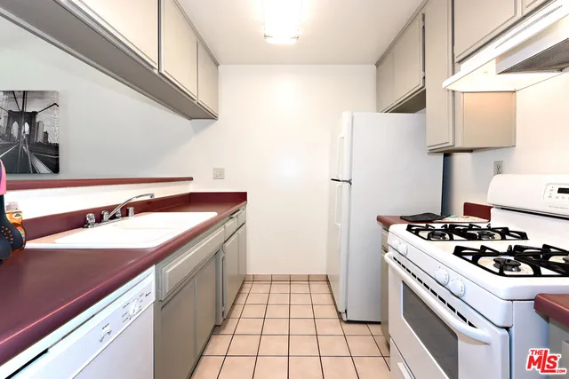 a kitchen with a sink a stove and a refrigerator