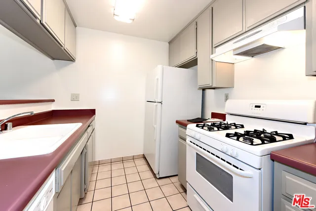 a kitchen with a stove and a refrigerator