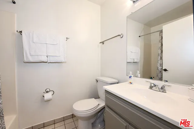 a bathroom with a sink toilet and mirror