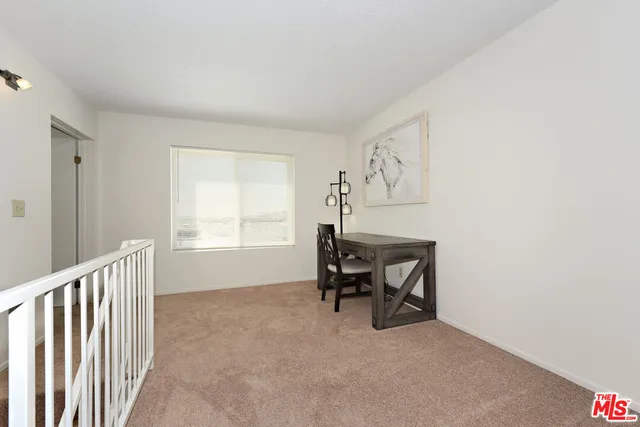 a view of a livingroom with furniture and window
