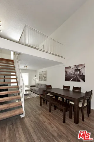 a view of a workspace with furniture and wooden floor