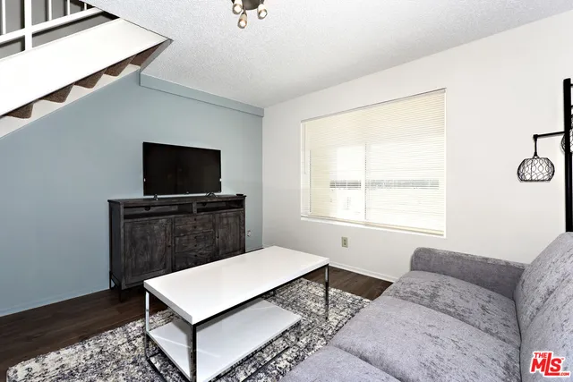 a living room with a couch and a flat screen tv