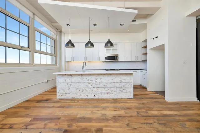 a view of living room with granite countertop cabinets and wooden floor